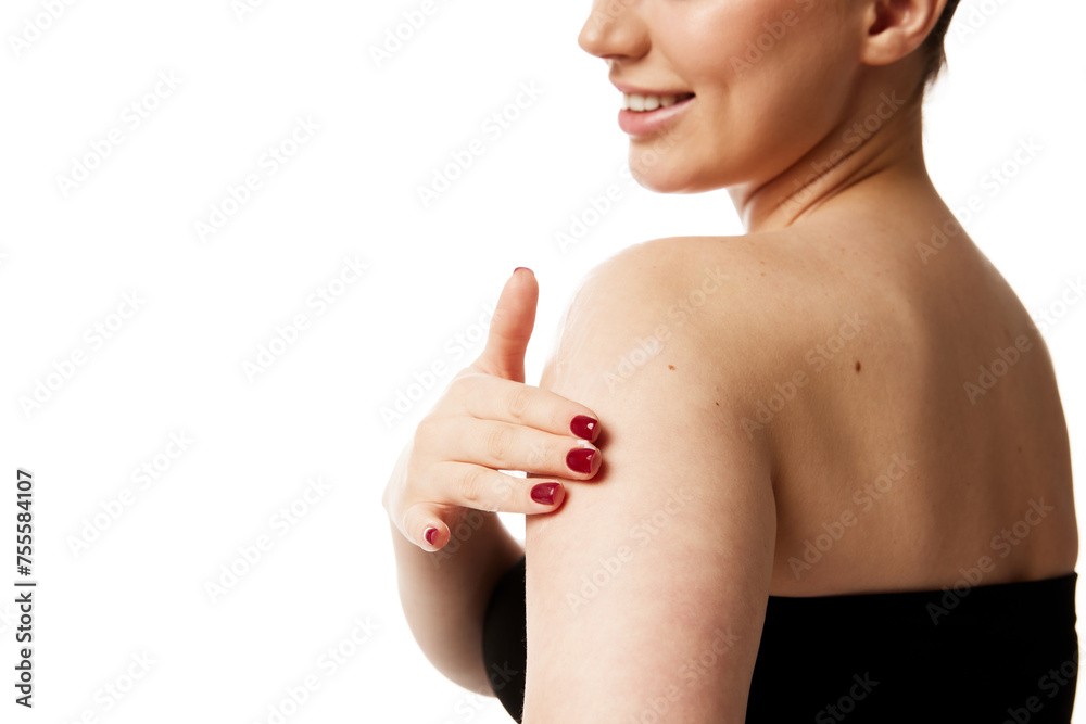Cropped portrait of young attractive woman gently touching her shoulder enjoying soft skin against white studio background. Concept of natural beauty people, injections, spa procedures, cosmetology. Cropped portrait of young attractive woman gently touching her shoulder enjoying soft skin against white studio background. Concept of natural beauty people, injections, spa procedures, cosmetology.