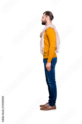 Full size fullbody snap, side view half face portrait of handsome attractive stylist in sweater, jeans having scarf around neck isolated on grey background