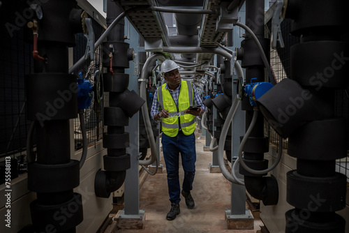 Industrial engineer check the air conditioning cooling system on site. engineer visit and inspection site engineer at industrial site. Inspector engineer check and working on site © kanpisut