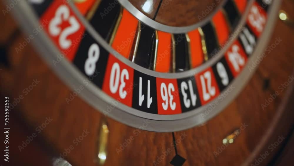 Red color casino roulette, poker game. roulette wheel. Casino theme, betting, online casino, bets, winnings. wooden casino roulette wheel with ball. Luxury casino roulette. close-up video Red color casino roulette, poker game. roulette wheel. Casino theme, betting, online casino, bets, winnings. wooden casino roulette wheel with ball. Luxury casino roulette. close-up video