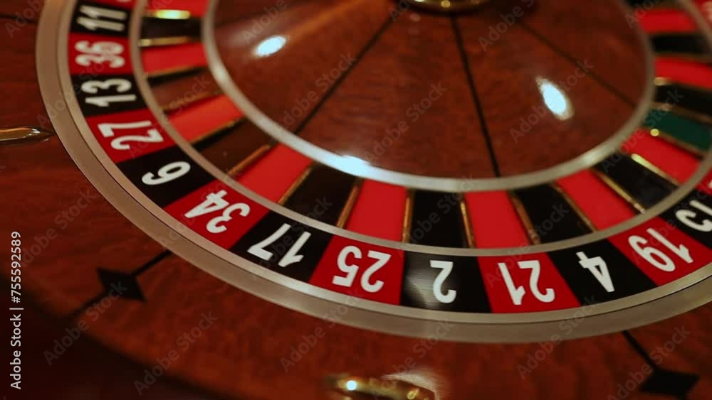 Red color casino roulette, poker game. roulette wheel. Casino theme, betting, online casino, bets, winnings. wooden casino roulette wheel with ball. Luxury casino roulette. close-up video Red color casino roulette, poker game. roulette wheel. Casino theme, betting, online casino, bets, winnings. wooden casino roulette wheel with ball. Luxury casino roulette. close-up video