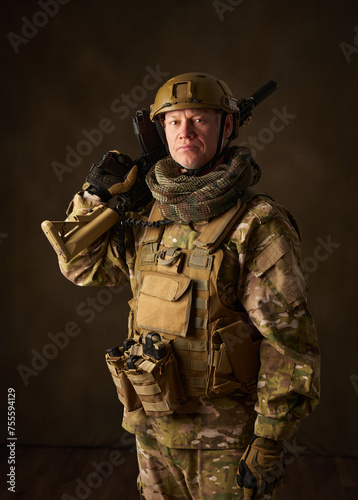 portrait of an airsoft soldier with camouflage clothing and a rifle with a telescopic sight