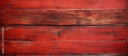 Detailed close-up view of an old red wooden wall with a solid, hard texture. The panels show signs of age with pale color and scratches.
