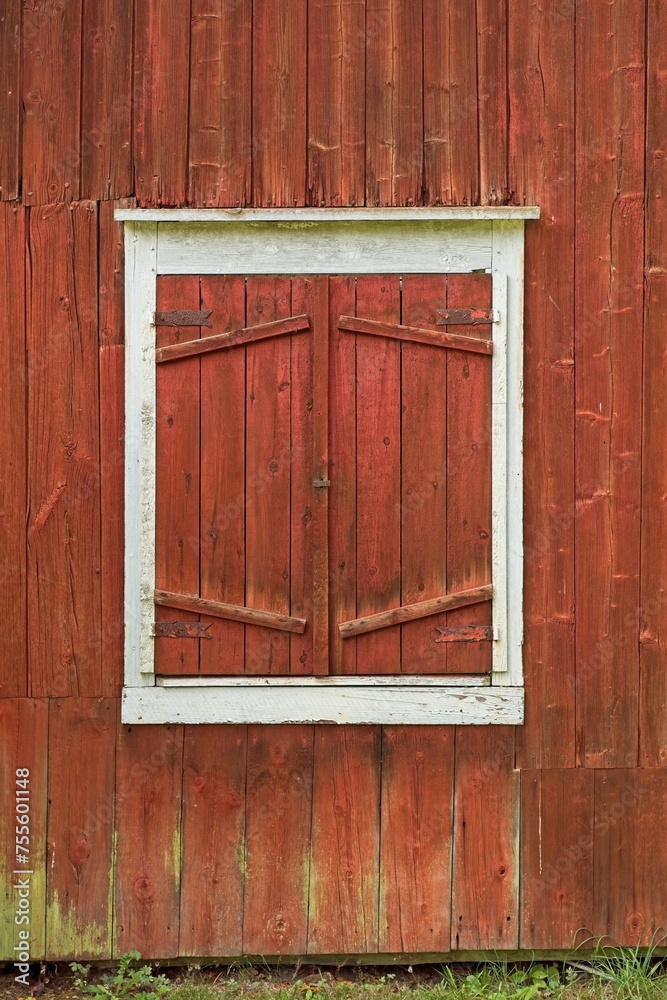 Red door on a old red painted wooden building. Red door on a old red painted wooden building.