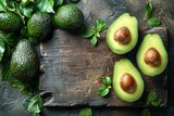 Fresh avocados are placed on a wooden cutting board, surrounded by vibrant green leaves.