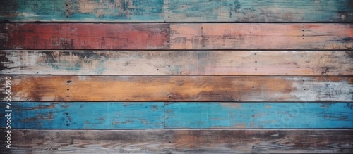 A close-up view of an old wooden wall painted with shades of blue and brown. The textured surface shows the brush strokes and details of the weathered wood.