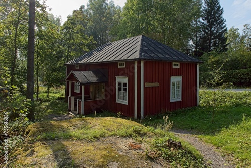 Old traditional style red wooden house in summer, Finland.