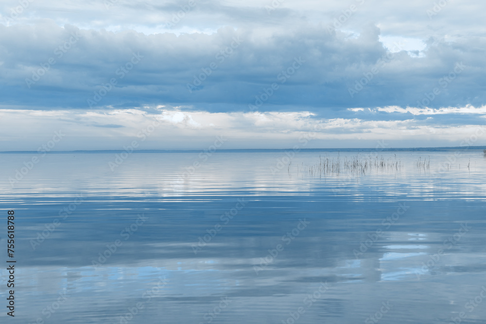Nature picturesque landscape, clouds reflected on water surface, windless summer weather, tranquil blue trend sky background, mirroring sky on water, white blue nature gradient, aesthetic