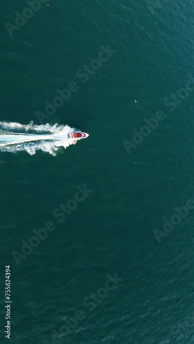 Wallpaper Mural Aerial drone shot over the boat. Foam trail with waves. High speed white yacht from above. Vertical video. Torontodigital.ca