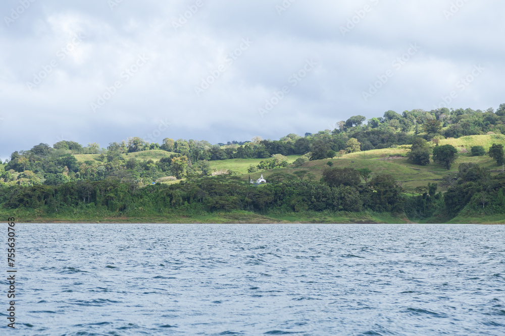 Small church overlooking the lake Arenal seen during a partly cloudy day, Alajuela Province, Costa Rica