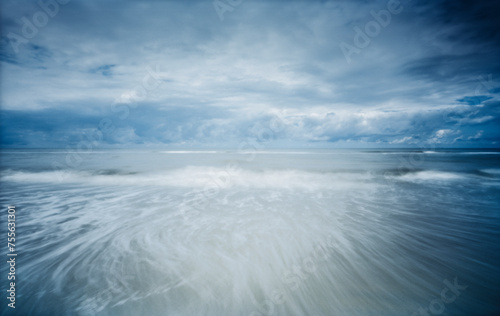 Moody Seascape Photographed with Pinhole on Film. Analogue photo in which sand, sea, waves clouds mix with time. Long exposure of the North Sea