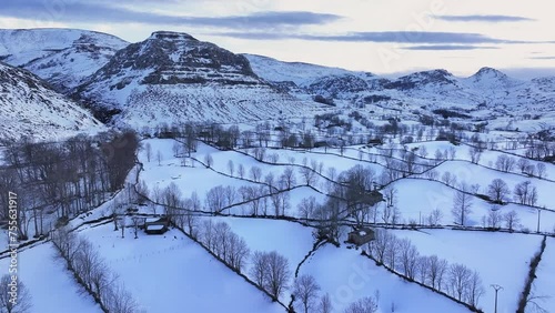 Winter landscape covered in snow in the surroundings of Guarguero waterfalls around the port of Estacas de Trueba. Aerial view from a drone. Espinosa de los Monteros. Pasiegos Valleys. Burgos. Castile photo