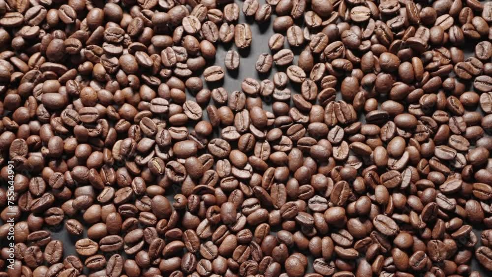Coffee beans roasted exploding background close-up slide macro on surface premium coffee beans towards camera slow motion. Pattern of roasted Arabica coffee beans taking off. Organic concept Coffee beans roasted exploding background close-up slide macro on surface premium coffee beans towards camera slow motion. Pattern of roasted Arabica coffee beans taking off. Organic concept