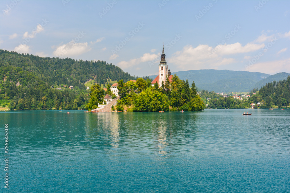 Cloudy summer day by the lake Bled in Slovenia with its clear turquoise water and famous baroque church on a Bled island