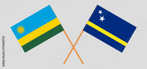 Crossed flags of Rwanda and Country of Curacao. Official colors. Correct proportion