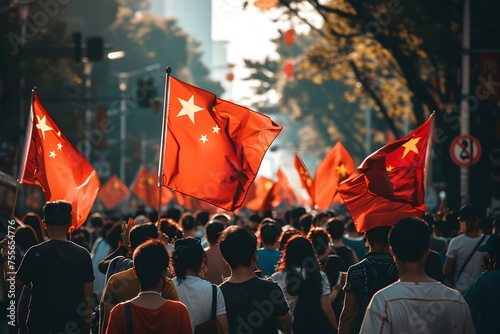 people celebrating and waving chinese flags on street