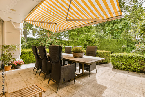 Elegant Patio Dining Area with Retractable Awning photo