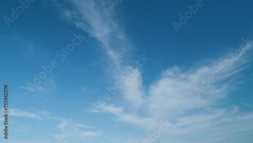 Beautiful blue sky and white cirrus clouds. White cloud like a swan wing high in a blue sky. photo
