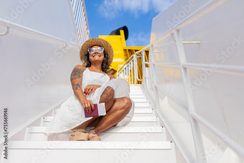 Joyful woman on cruise ship staircase during getaway