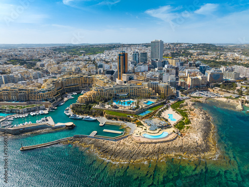 Aerial view of St. Julian's city and modern high buildings. Day. Maltese island