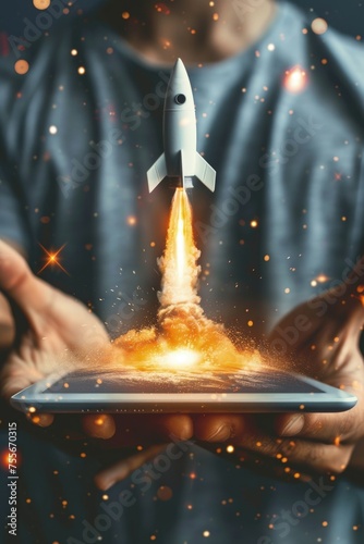 Man holding tablet with rocket taking off from the screen, startup, business and technology concept. © Deivison