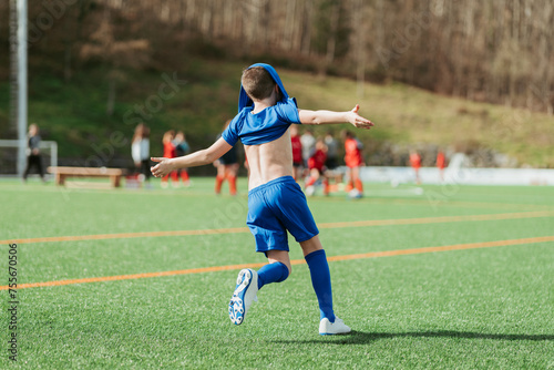 Young soccer player celebrating on the field photo