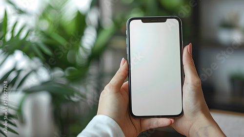 Business man hand holding white blank mobile phone in office