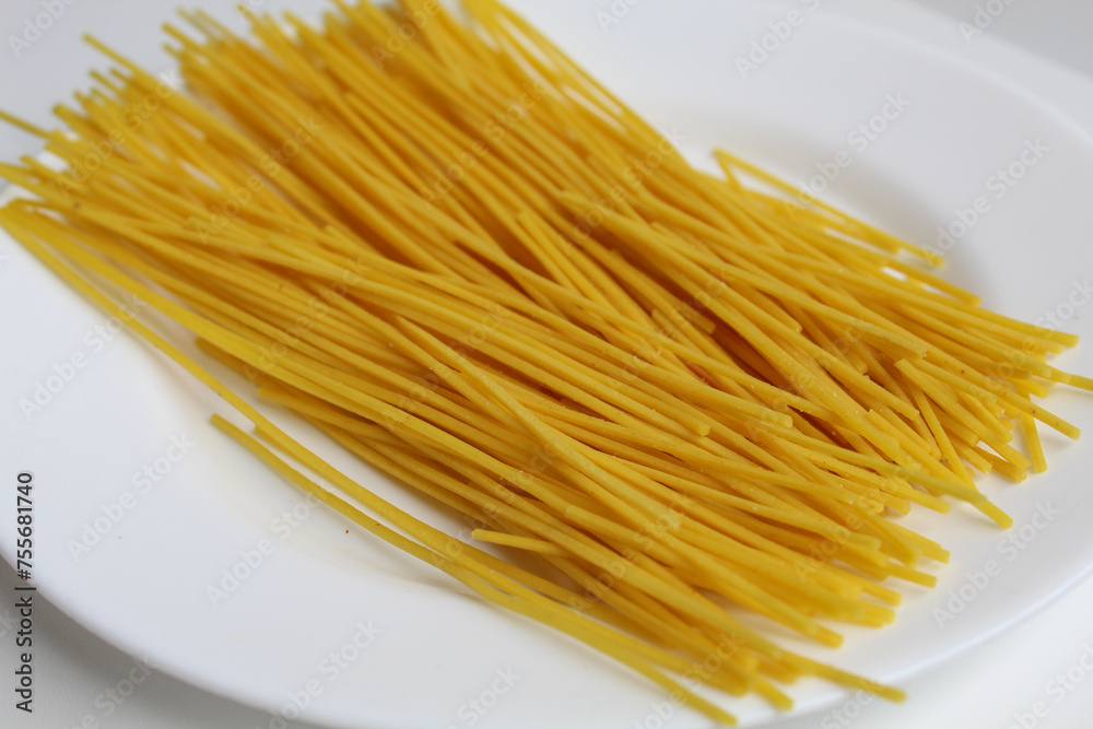 Mie lidi, traditional snack from Indonesia. Noodle-like texture, fried and salted, on white background Mie lidi, traditional snack from Indonesia. Noodle-like texture, fried and salted, on white background