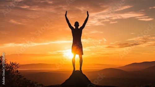 A male tourist stands triumphantly on a mountain summit at sunrise, embracing the breathtaking view. He is wearing casual attire and exudes joy and accomplishment in this vibrant scene.