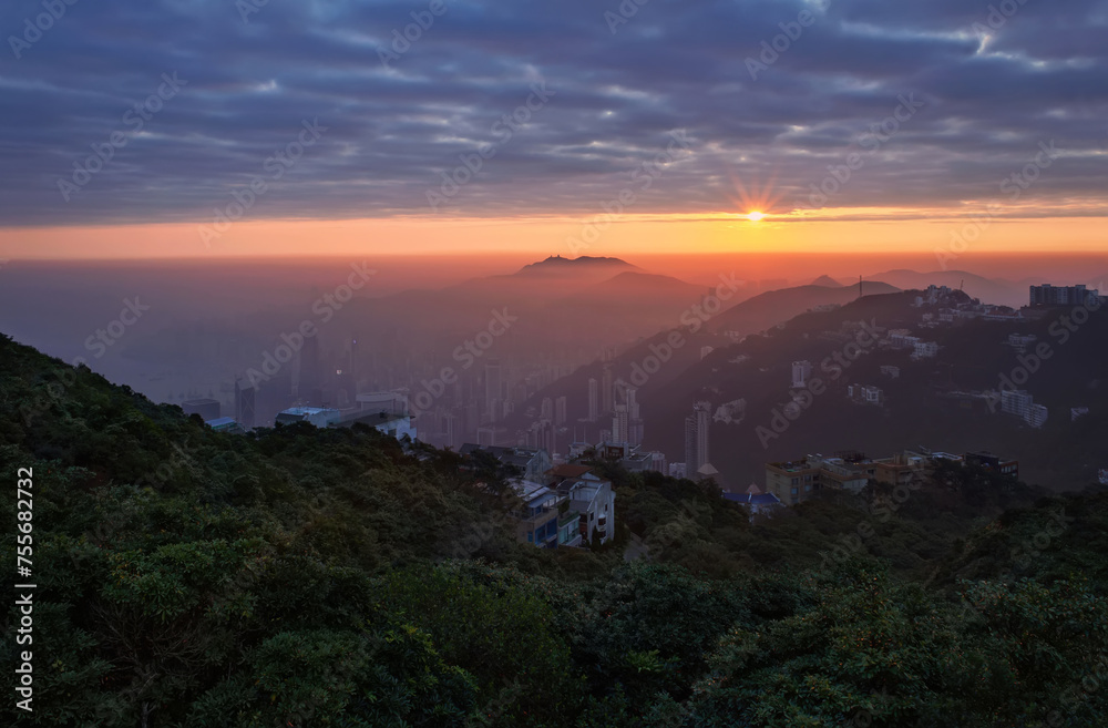Green mountains, residential buildins and sunrise in Hong Kong, China