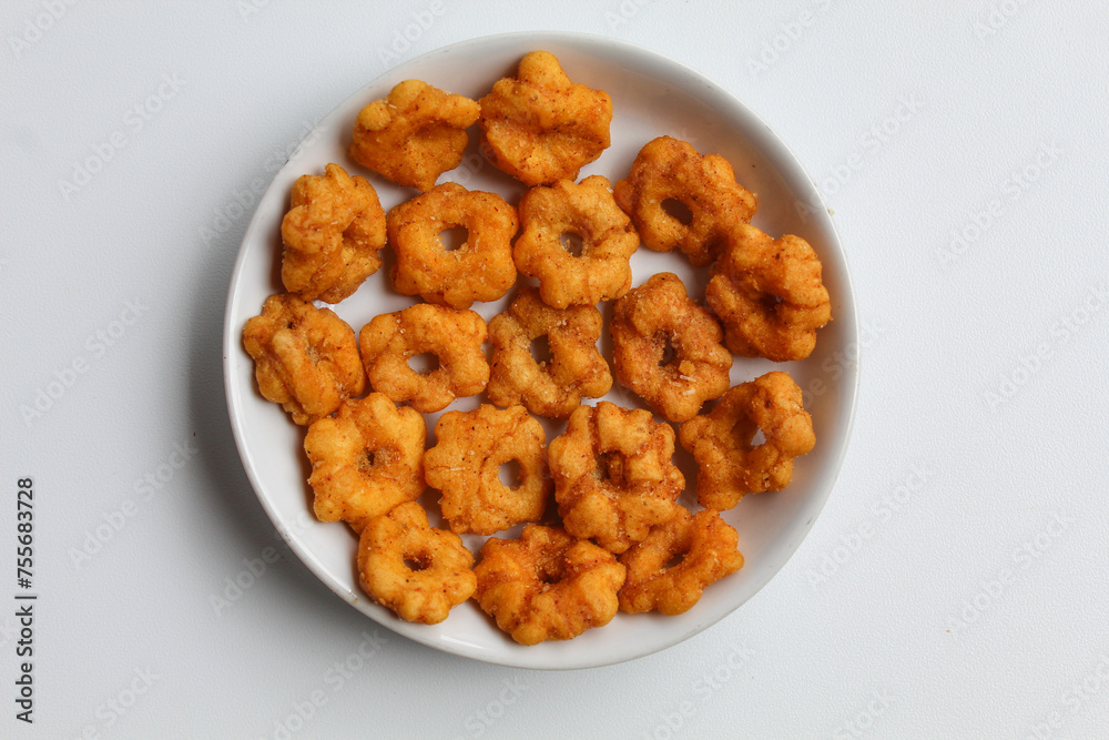 Sakura ribut, fried dough with flower shape, savory taste. Snack from Indonesia. Isolated on white background, flat lay or top view Sakura ribut, fried dough with flower shape, savory taste. Snack from Indonesia. Isolated on white background, flat lay or top view