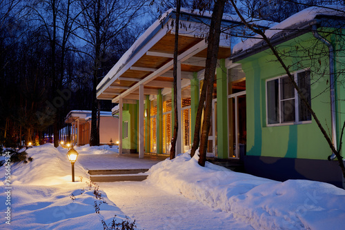  One-storeyed illuminated holiday hotels on winter evening 