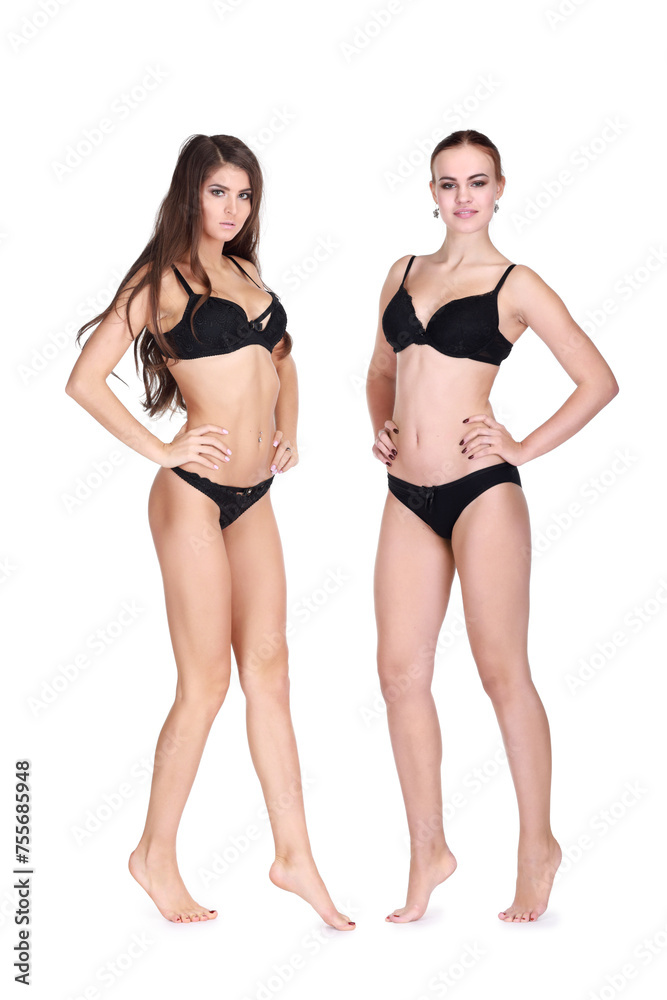 Two young women in black underwear pose isolated on white background Two young women in black underwear pose isolated on white background