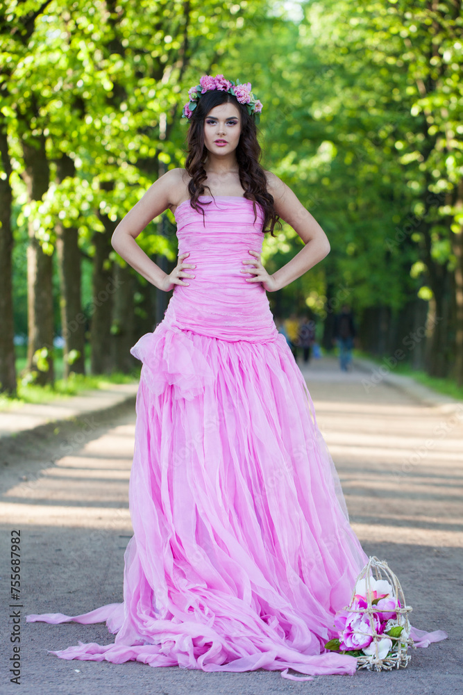 Romantic young adult lady with with long hair, make-up and pink flower in spring park. Beauty woman portrait Romantic young adult lady with with long hair, make-up and pink flower in spring park. Beauty woman portrait