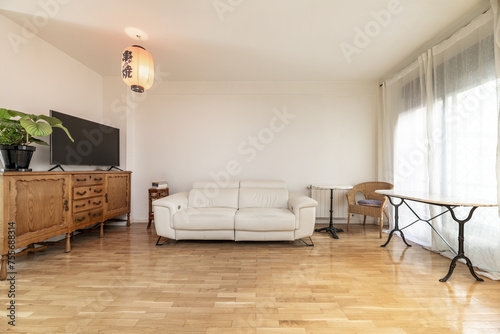 Apartment with kitchen with brown furniture  white countertop  stools with chrome legs 