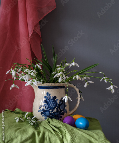 A still life arrangement of Easter eggs, spring flowers. Still life with snowdrops and ester eags.