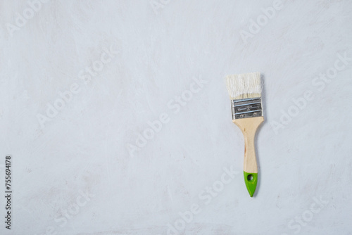 Paintbrush with paint on a white primed surface