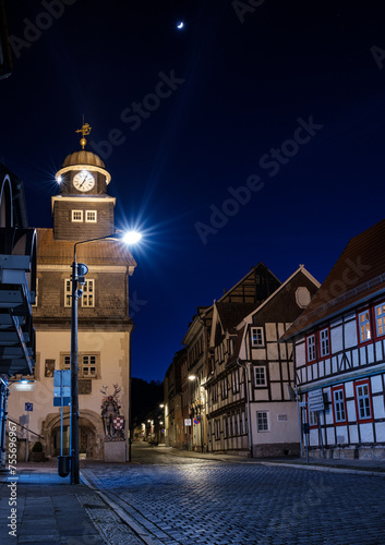 Street alley in the small town of Schwabisch Hall, with houses and buildings with typical German architecture and street lanterns, at night.