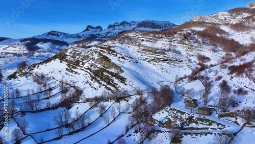 Winter landscape covered in snow in the surroundings of Guarguero waterfalls around the port of Estacas de Trueba. Aerial view from a drone. Espinosa de los Monteros. Pasiegos Valleys. Burgos. Castile photo