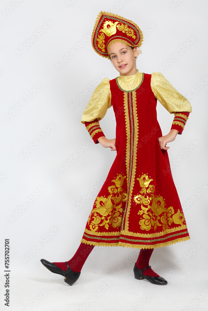 Pretty girl in red russian folk costume dances in white studio Pretty girl in red russian folk costume dances in white studio