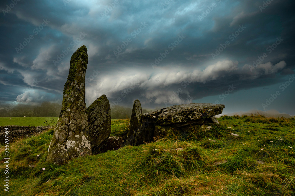 Prehistoric burial mound with stormy sky