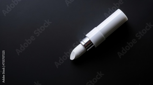 White lipstick on black background. Single object isolated for design projects. Elegant beauty product perfect for makeup concepts. Suitable for stock photos, fashion blogs, and more.