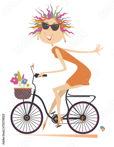 Pretty young cycling woman with bouquets of flowers in the basket. Cycling woman carries bouquets of flowers in the basket 