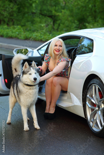 Beautiful woman (MR) with husky near sport car. Lamborghini Huracan is world first production car, using inertial navigation system