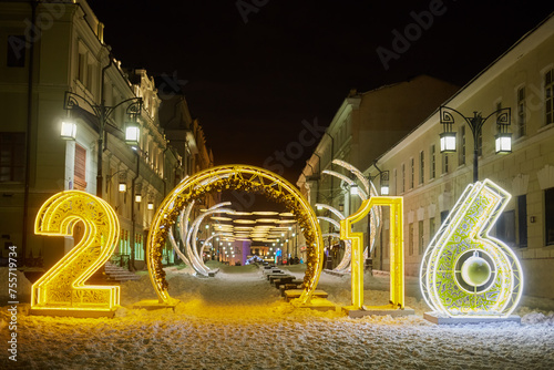  Illuminated gate in form of 2016 number between houses at Kamergersky Lane on winter night photo