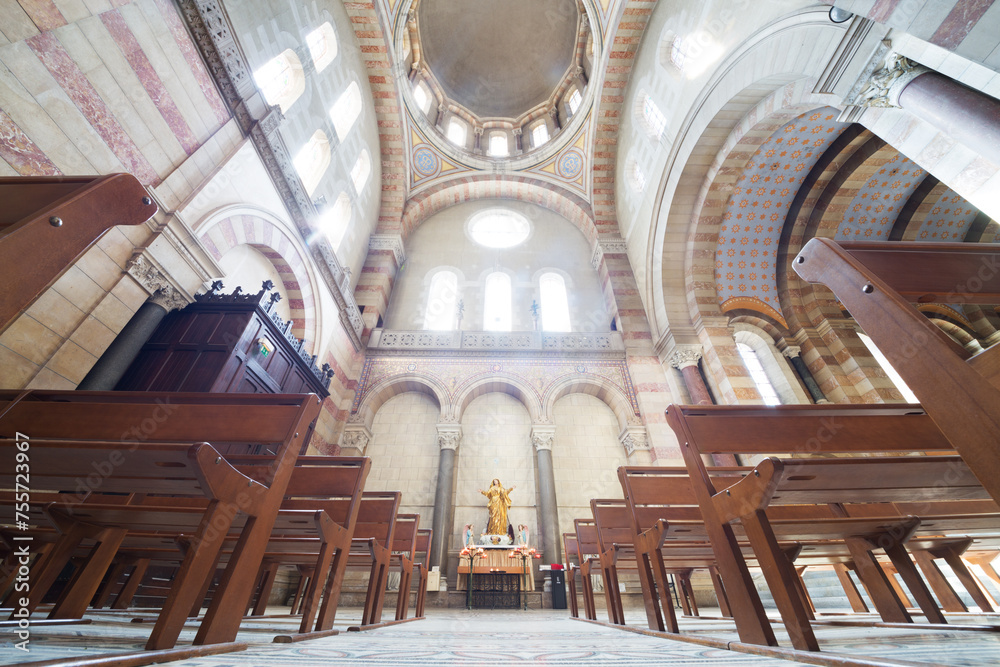  Interior of sunny Marseille cathedral with wooden benches