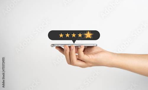 Hand holding smartphone show five golden stars for client the best experience after use product and get service , customer feedback evaluation and satisfaction concept.