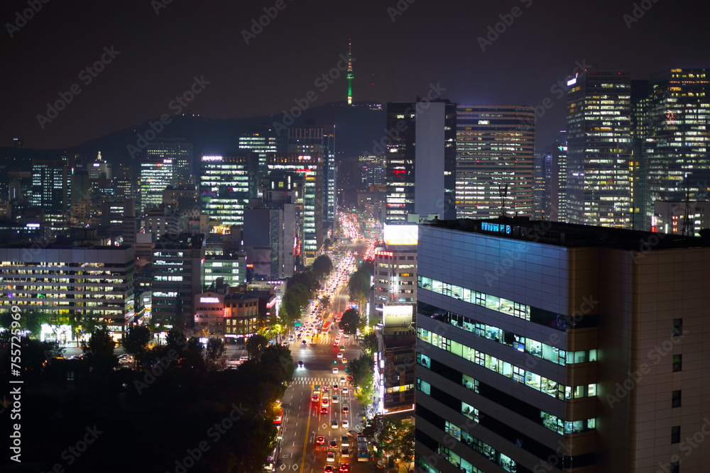  Panorama of city area with street traffic and TV tower at night
