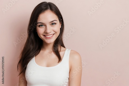 Happy young American woman wearing a white cropped tank top on a pink background with copy space. © PNG&Background Image
