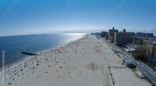 Cityscape with many people rest on Brighton Beach at summer sunny day. Aerial view photo